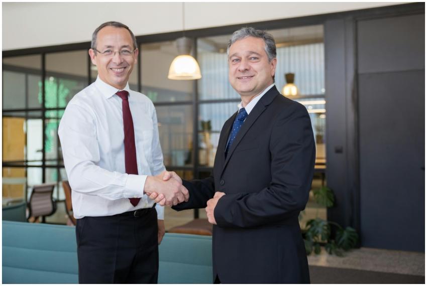 Two businessmen shaking hands in a modern office,