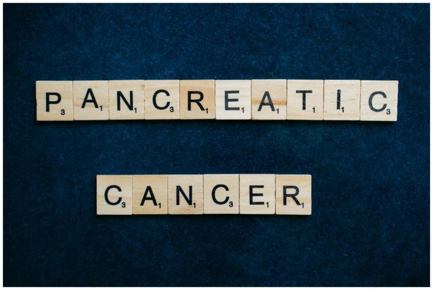 Wooden tiles spelling 'Pancreatic Cancer' on a tex