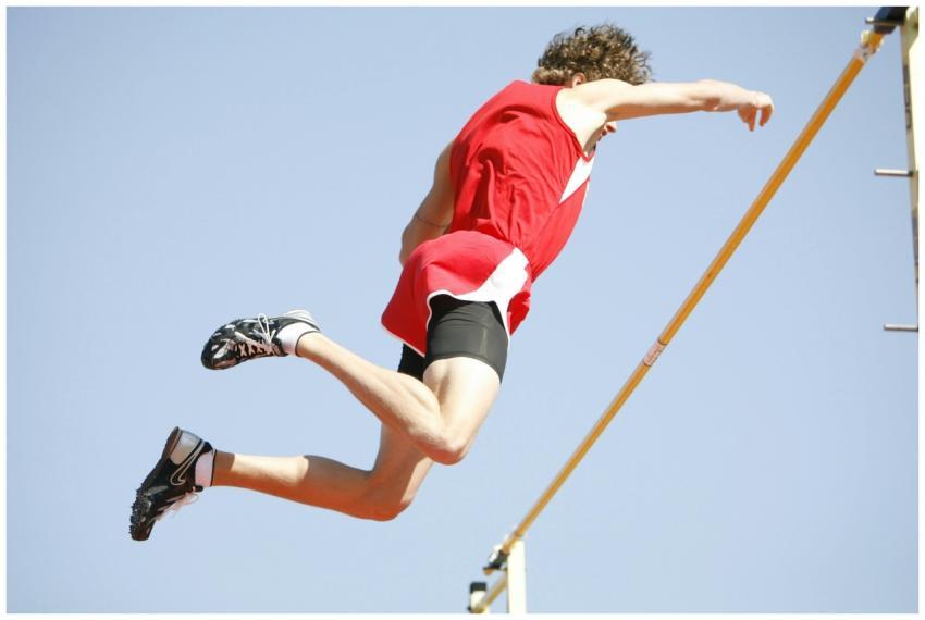 Dynamic shot of a male athlete doing a high jump o