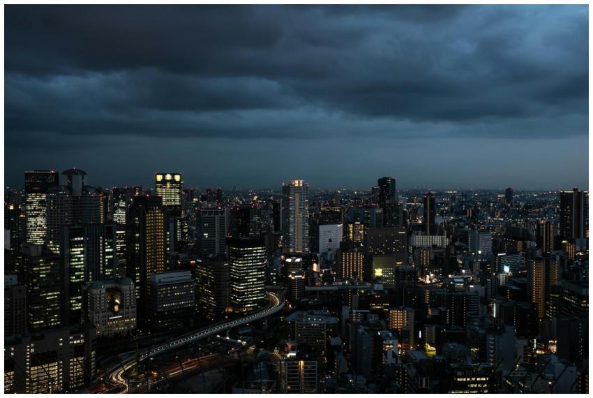 Dramatic Osaka skyline at twilight, showcasing ill