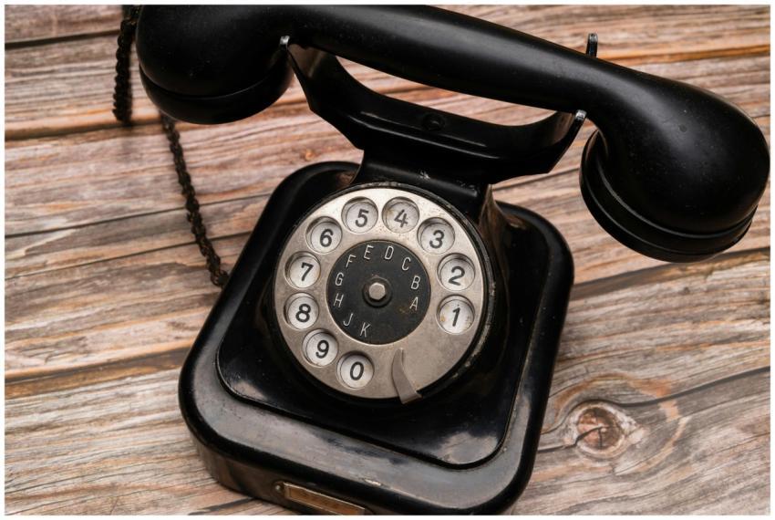 Close-up of a classic black rotary dial telephone