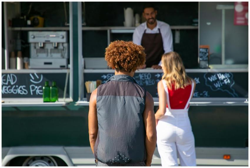 Back view of diverse clients standing near street