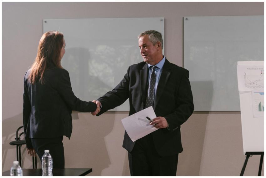 Two business professionals shaking hands in an off