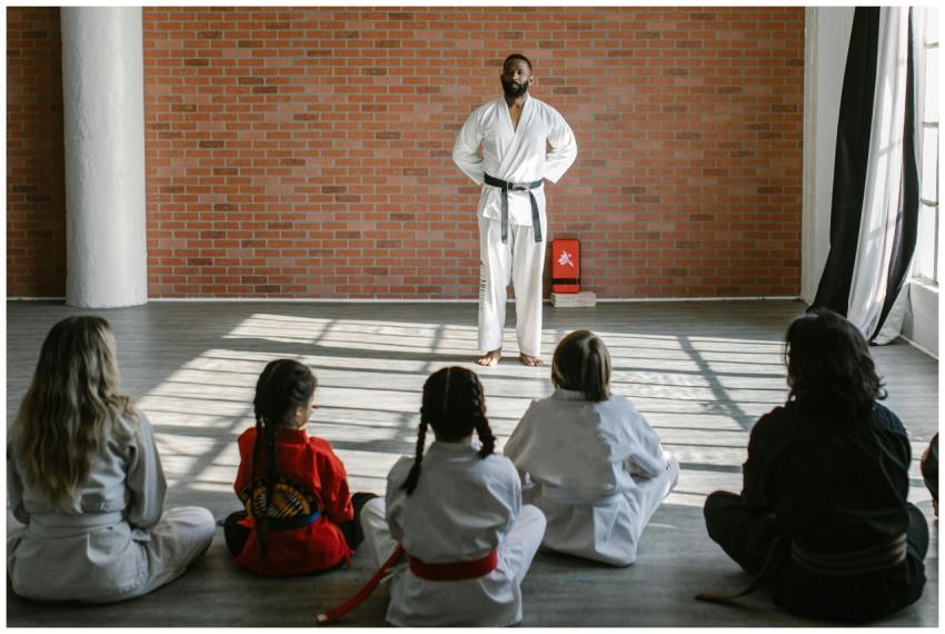 Young students in gis learn martial arts under the