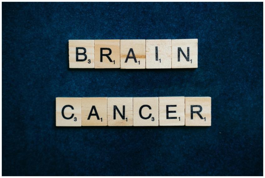 Wooden tiles spelling 'Brain Cancer' on a dark blu