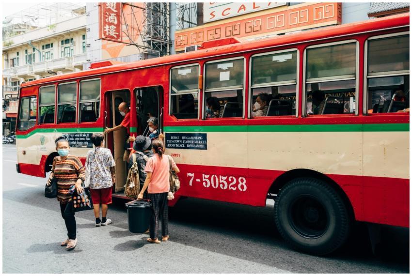 Vibrant city scene with people boarding a bus in b