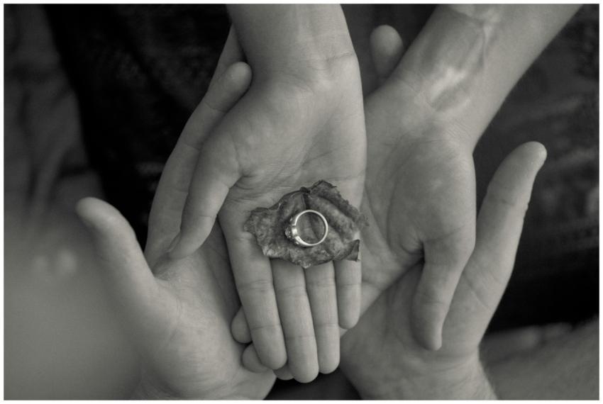 Black and white photo of a couple holding an engag