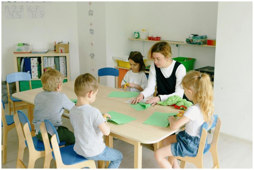 Children and teacher engage in a craft session usi