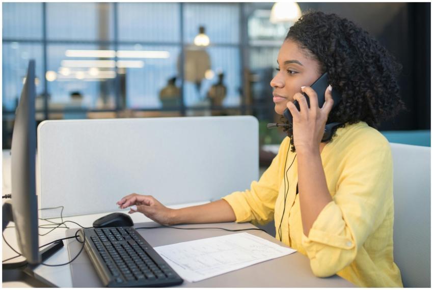 A young woman working in a modern call center envi