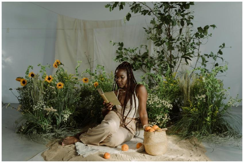 A woman in a peaceful garden setting reads a book,