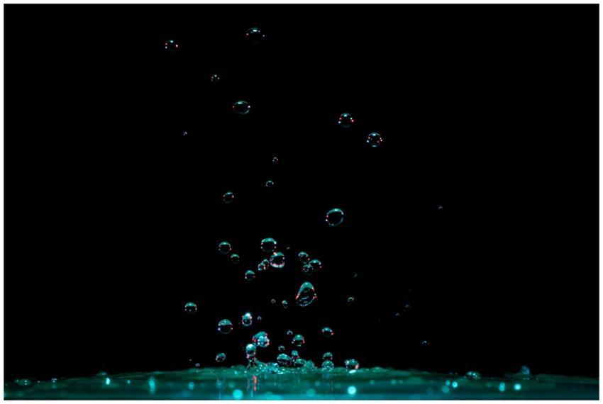 Vibrant close-up of water splash and bubbles risin