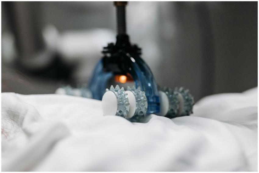 High-tech massage gadget resting on white fabric,