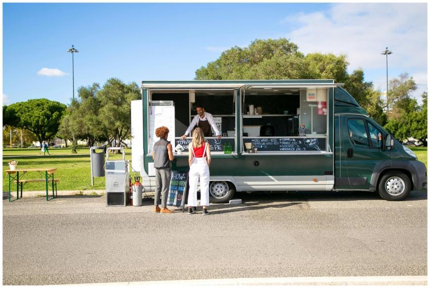 A vibrant outdoor scene with a food truck and cust
