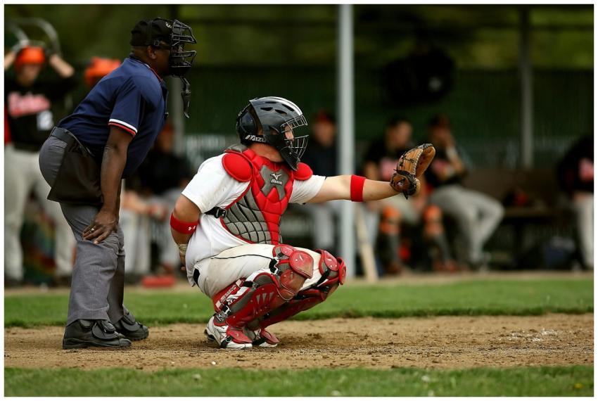 A baseball catcher and umpire in action during a g