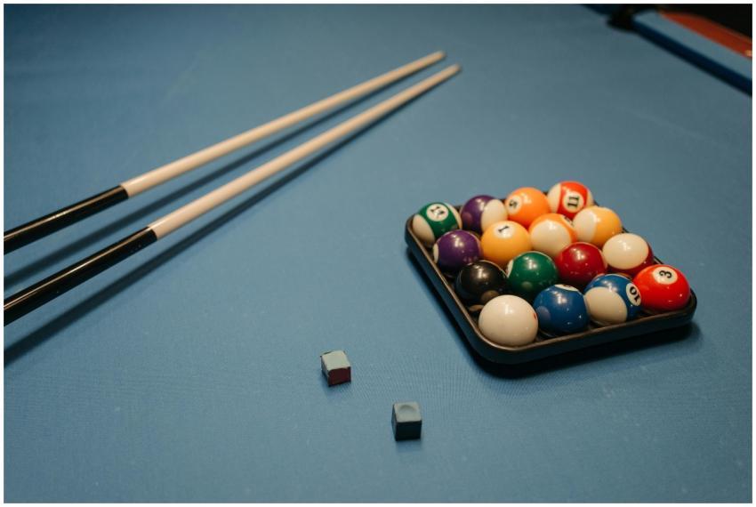 Arrangement of billiard balls and cue sticks on a