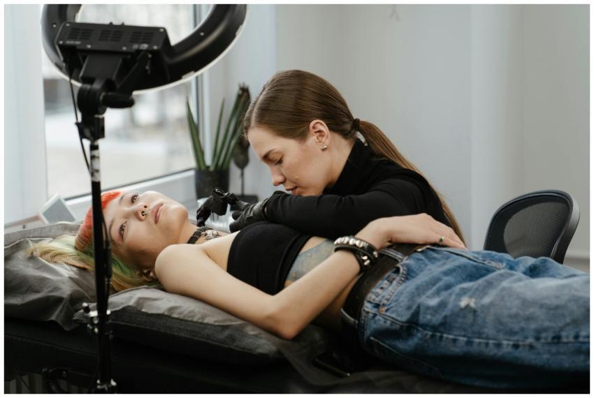 A female tattoo artist focused on her craft, tatto