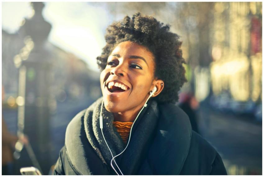 Smiling young woman enjoying music in urban Budape