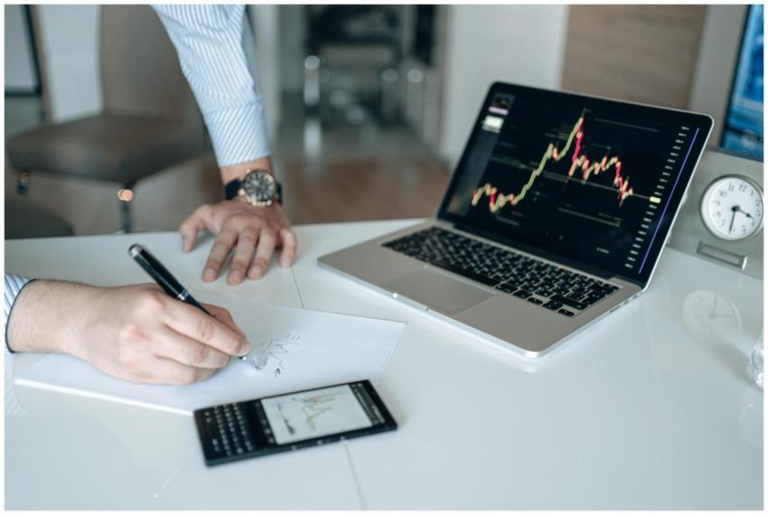 Professional workspace with a laptop displaying fi