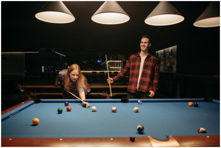 Friends enjoy a casual evening playing billiards,