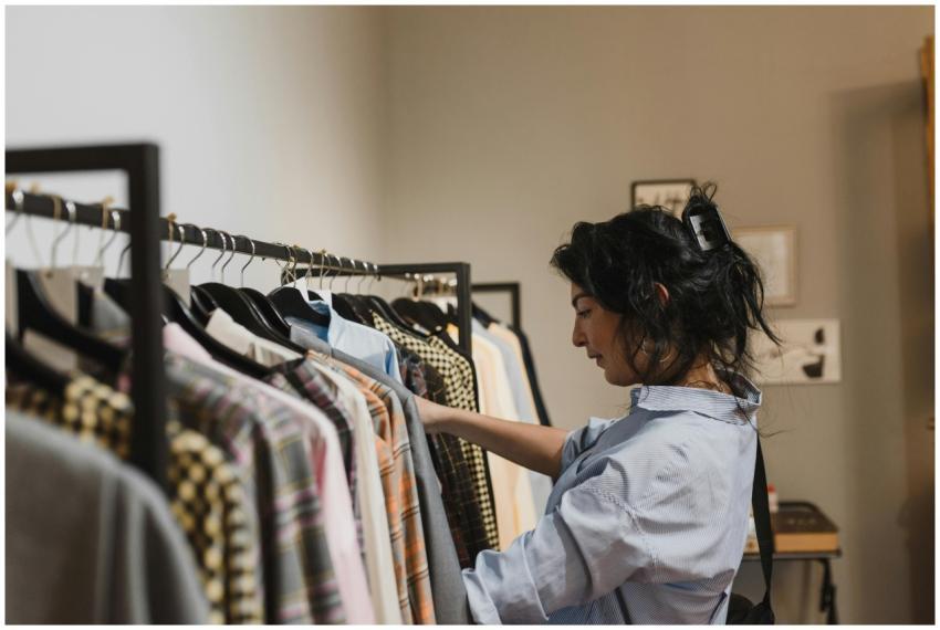 A woman exploring clothing options in a stylish bo