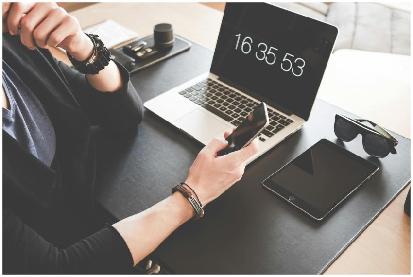A modern workspace featuring a laptop, smartphone,