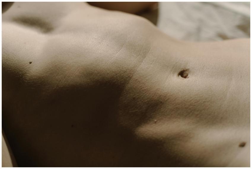 Detailed close-up of human skin featuring belly bu