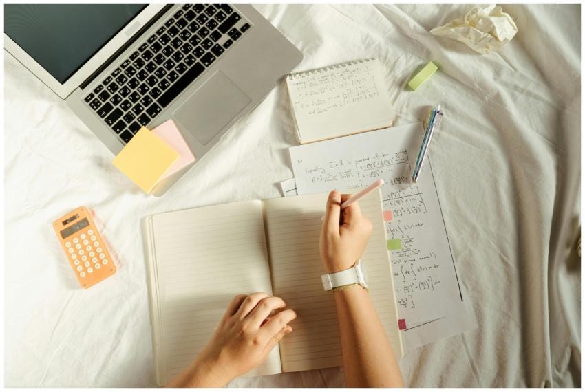 Student working on math problems with laptop and c