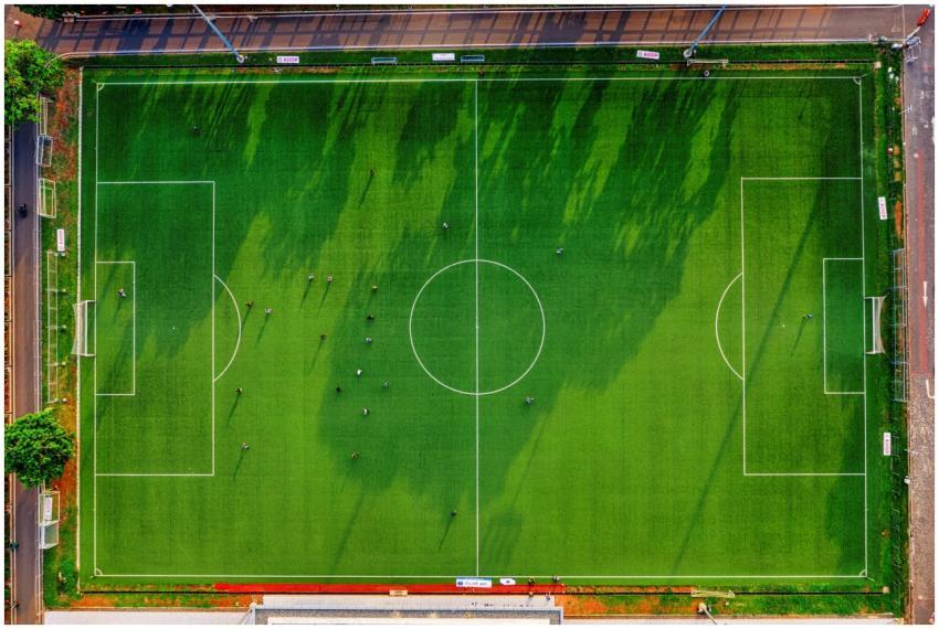 High-angle drone shot of a soccer field with playe
