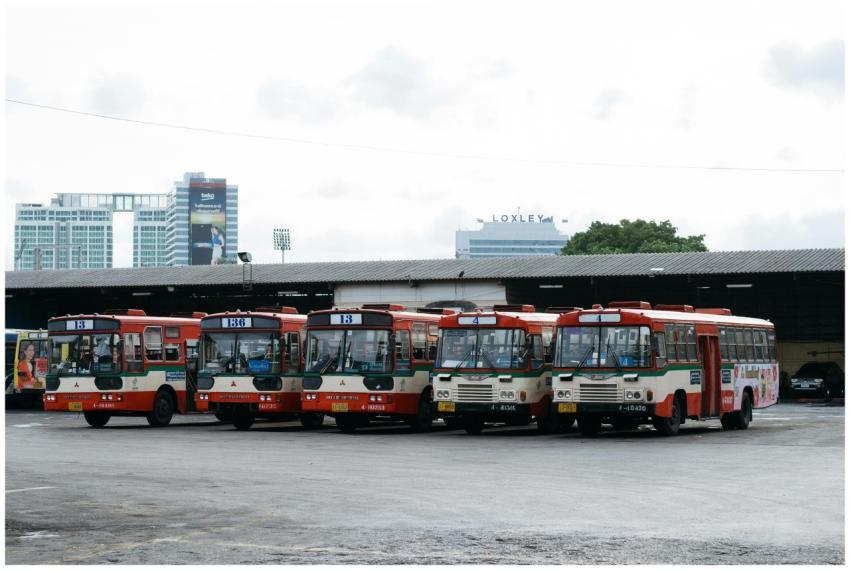 Five public buses lined up at a bus terminal in Ba