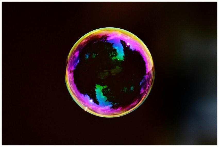 A single colorful soap bubble reflecting hues agai