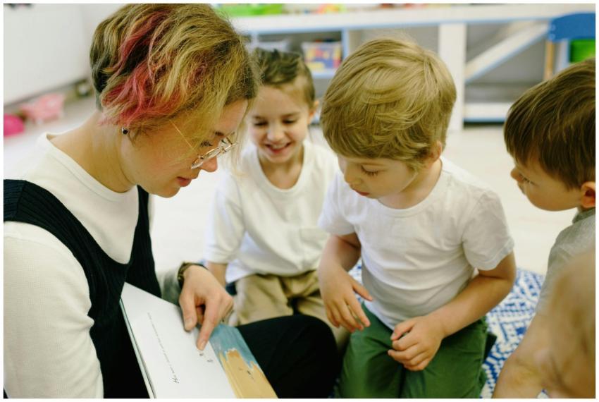 Teacher reading to children in a lively kindergart