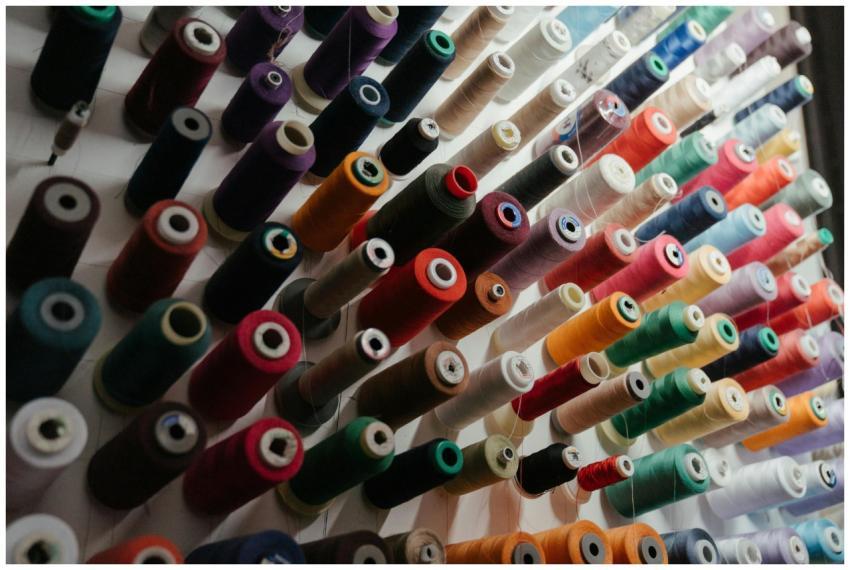 A vibrant array of sewing threads neatly organized