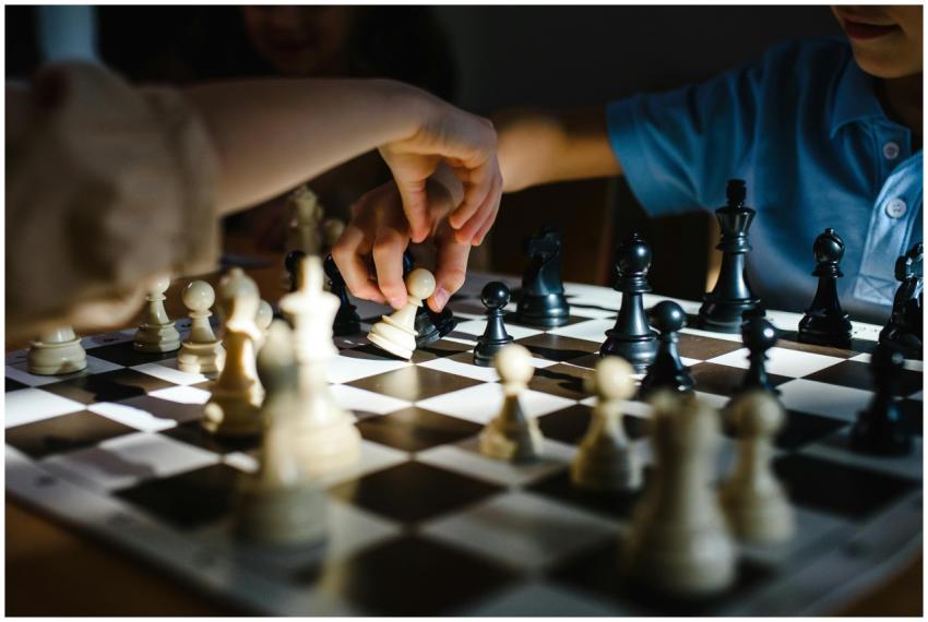 Hands engaging in a strategic chess game, showcasi