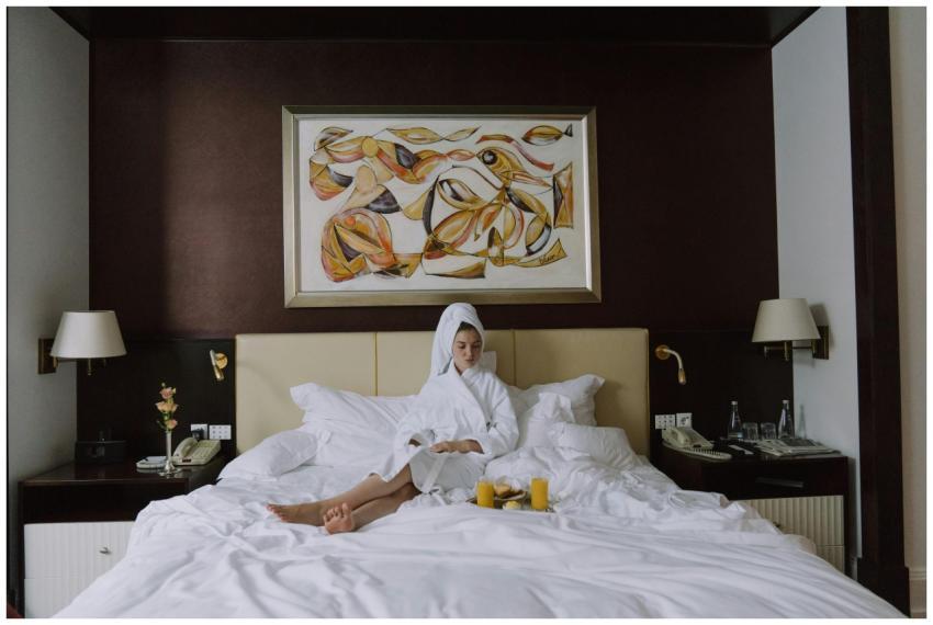 Woman enjoying breakfast in bed in a luxurious hot