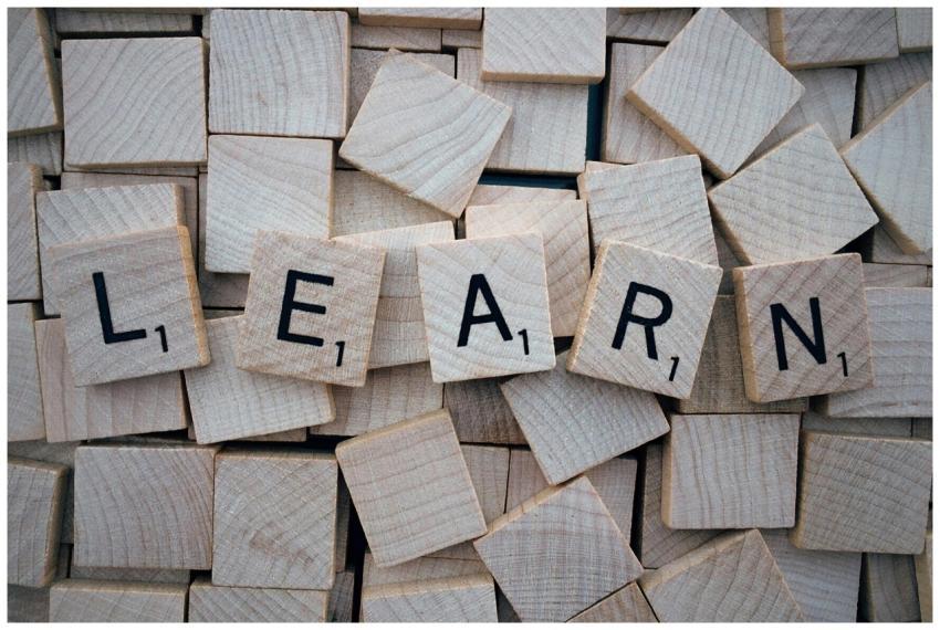 Wooden letter tiles arranged to spell 'learn' on a