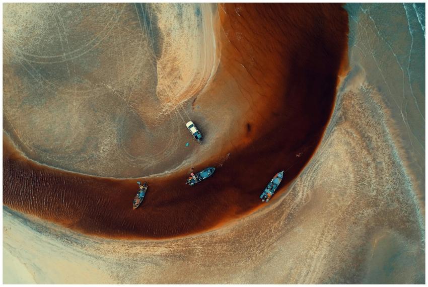 Stunning aerial view of boats on a sandy shoreline