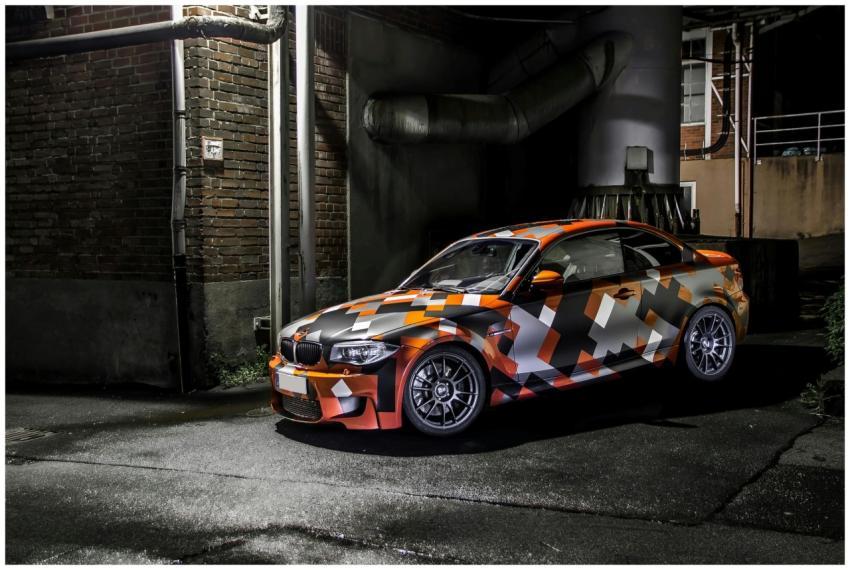 Eye-catching camo-wrapped car parked in an industr