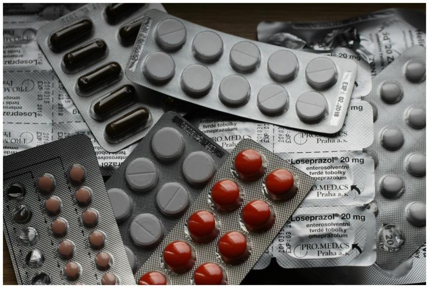 Close-up of various pills in blister packs showcas