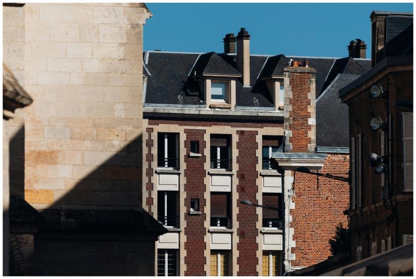 Historic brick and stone buildings under clear blu