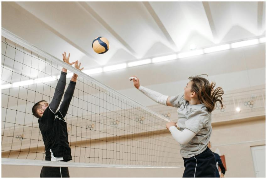 Two athletes engaged in a thrilling volleyball mat