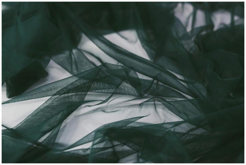 Close-up of a soft, dark green sheer fabric creati