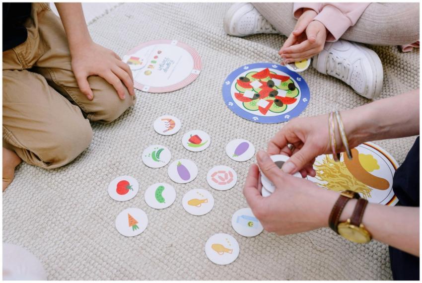 Children playing an educational card game inside,