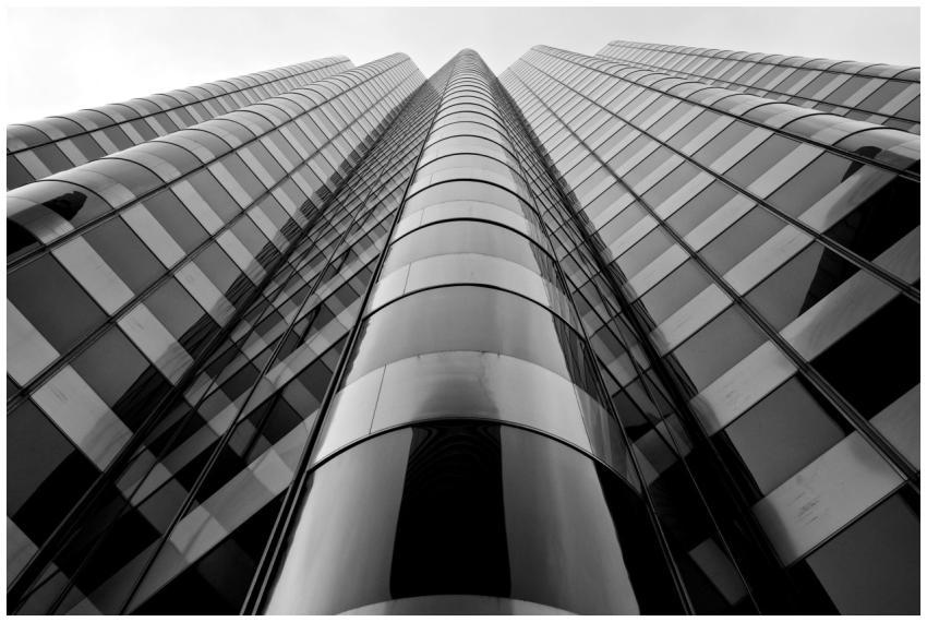 Low angle black and white view of a modern skyscra