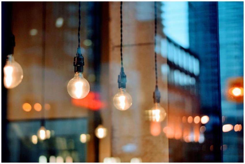 A creative shot of illuminated bulbs with city ref