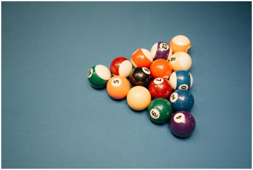 Vibrant billiard balls arranged on a baize pool ta