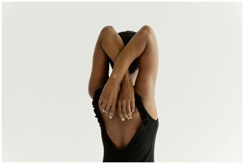 A back view of a woman in a black tank top stretch