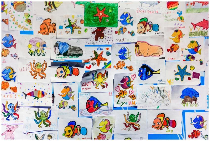 A colorful collage of children's drawings featurin