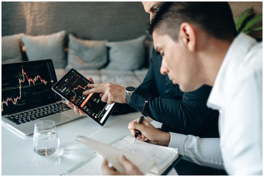 Two businessmen in a meeting analyzing financial d