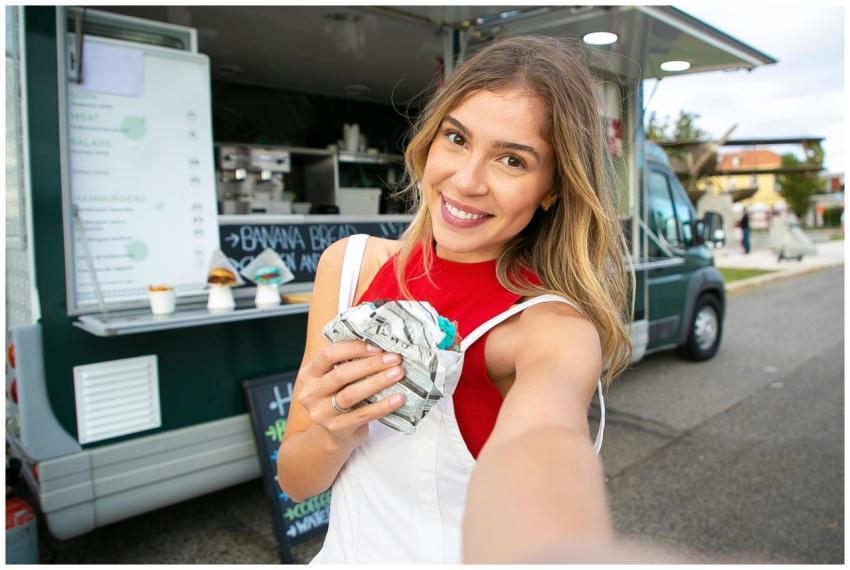 Happy young female in casual wear enjoying sweet d