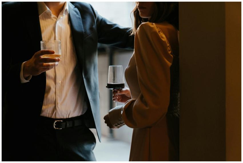 A stylishly dressed couple sharing a romantic mome